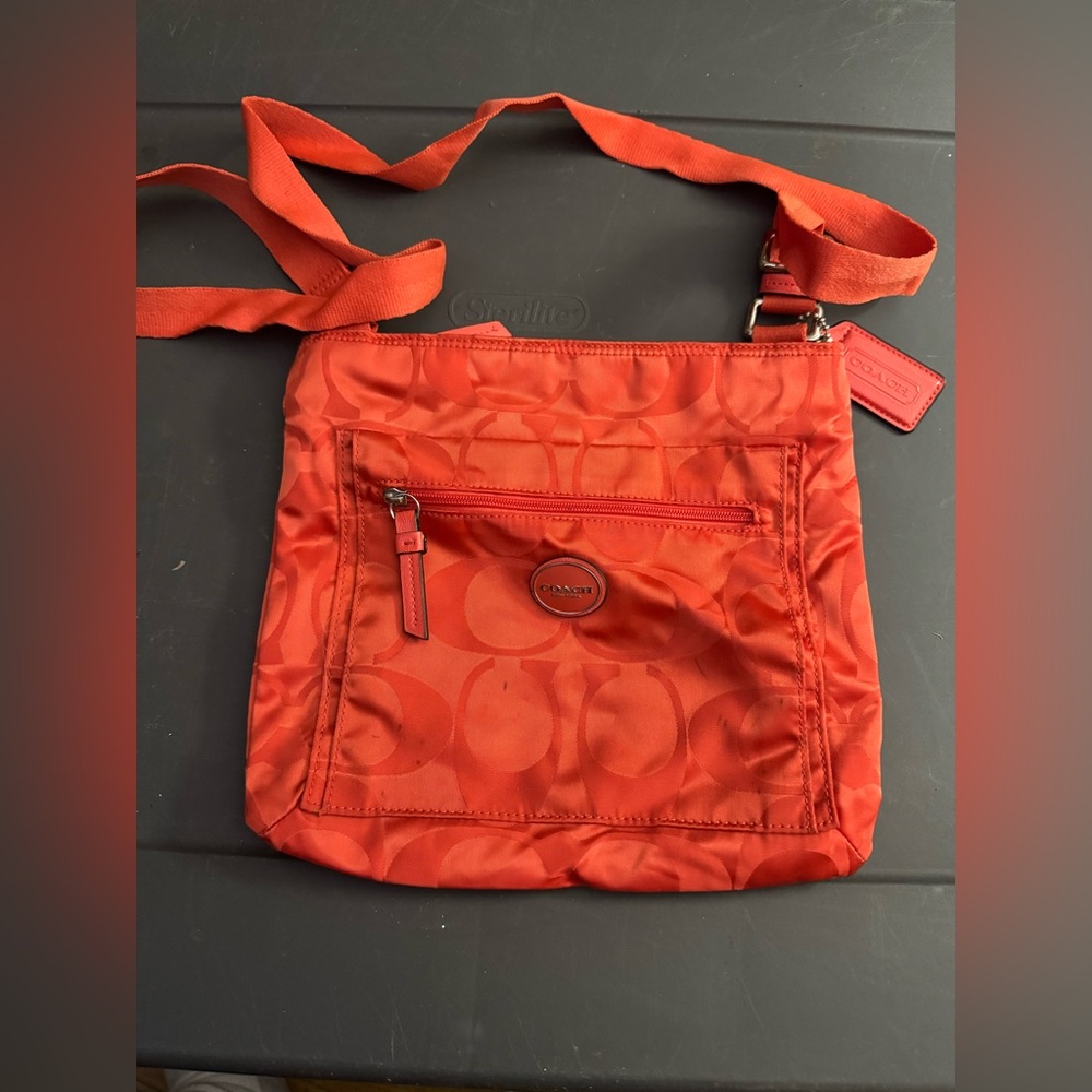 Orange crossbody Coach purse.